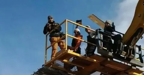 Star Boy Roofing crew on a lift platform at a job site