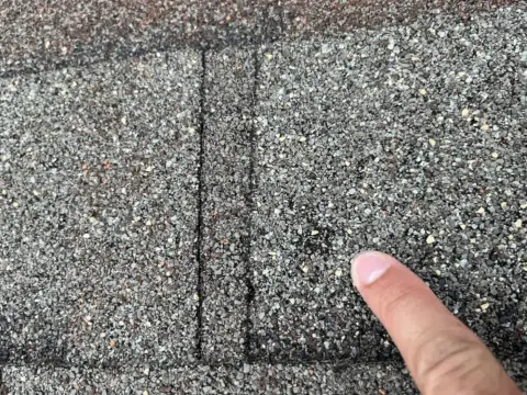 Close-up of worn shingles found during a roof inspection
